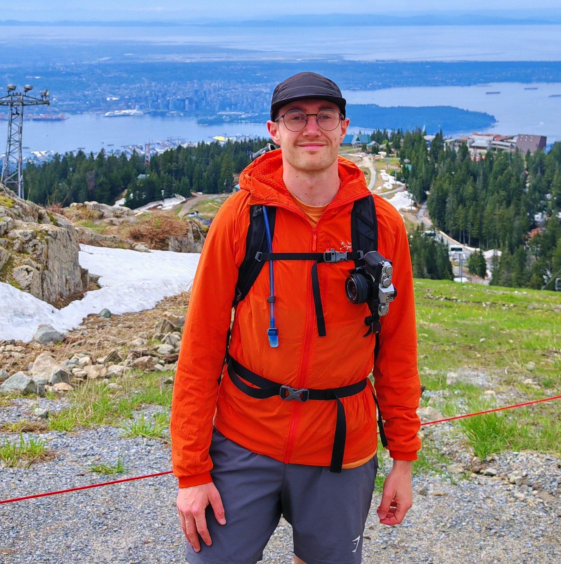 Close up of the Arc'teryx Proton LT Hoody worn as an outer layer on a rocky alpine ascent, highlighting the durable Fortius Air 20 face fabric.
