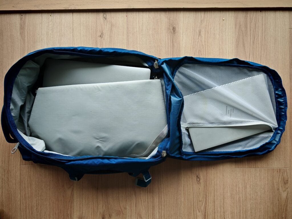 The Osprey Fairview 40 open with 2 laptops being stored in the dedicated laptop storage and mesh sleeve