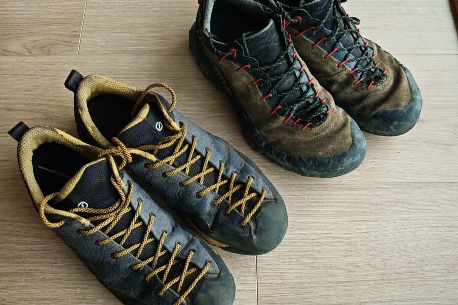 Scarpa Mescalito Planet Approach shoes and La Sportiva GTX TX4 placed side by side on a wooden floor for comparison.
