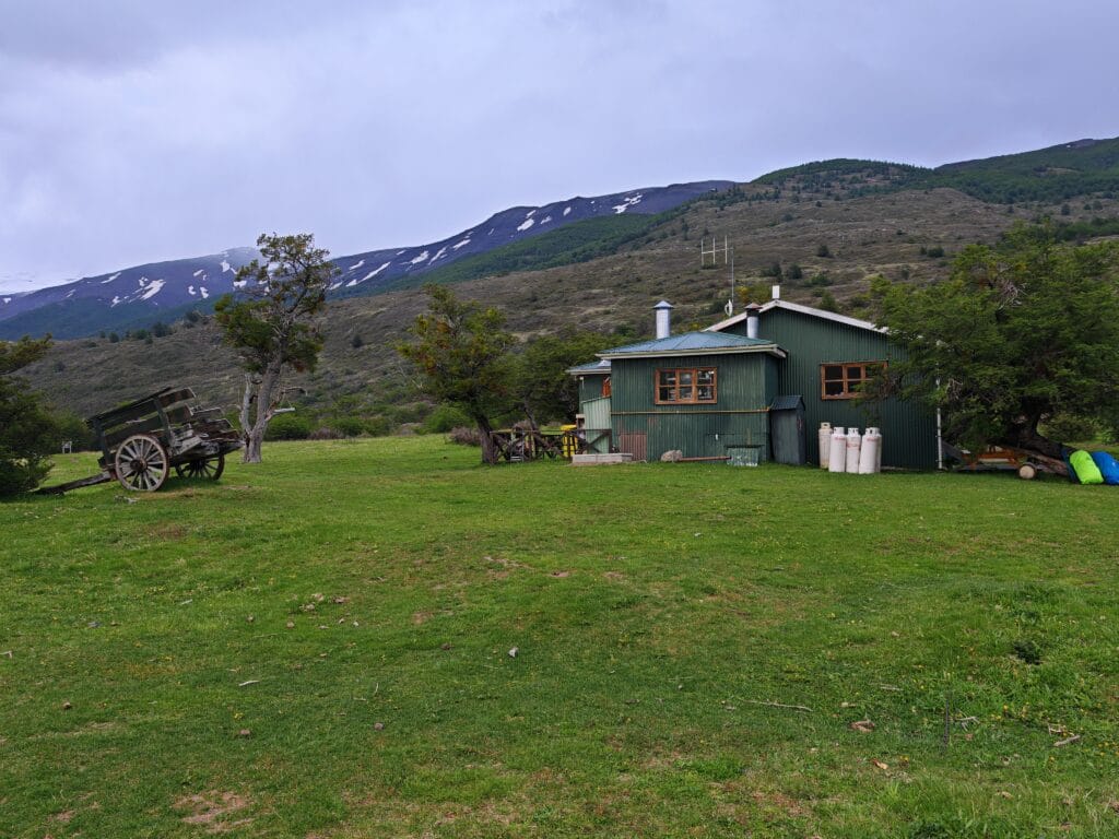Seron Camp hut in a green field on the O Circuit in Patagonia