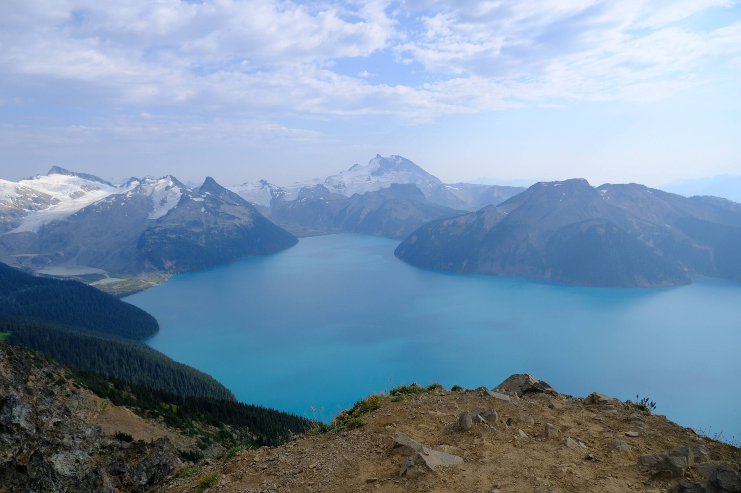 Panorama Ridge view of Garibaldi Lake below and snow capped mountains in the distance