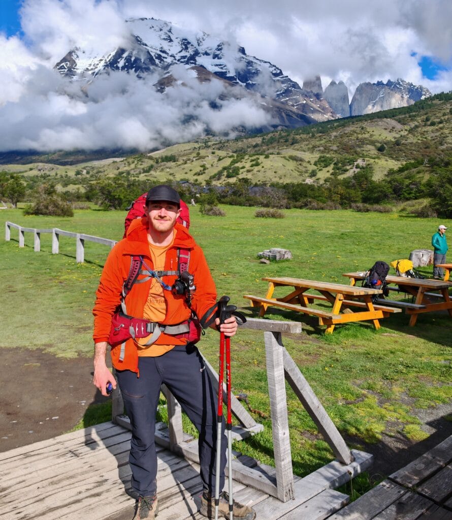 A happy trekker after completing the Torres del Paine O Circuit and W Trek at central carrying an osprey backpack