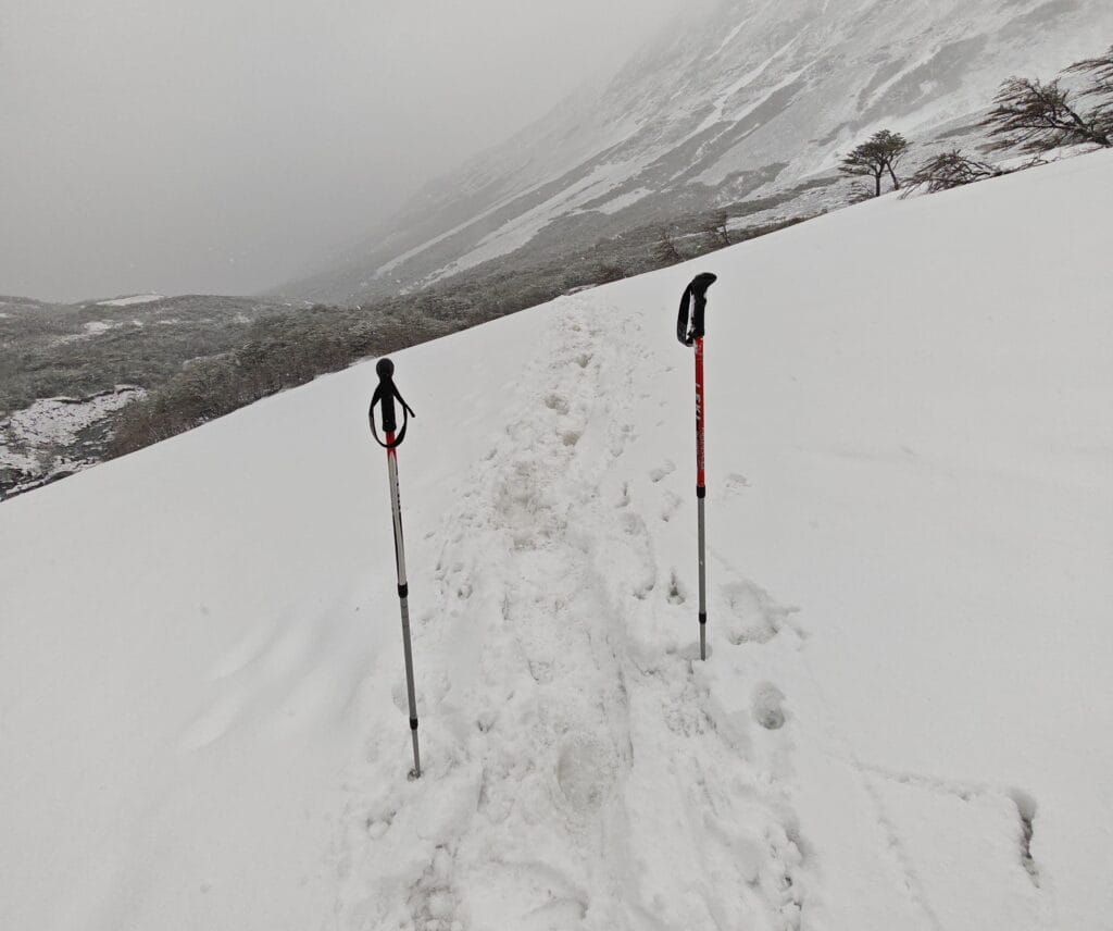 A snowy hiking path on the John Gardner Pass with Leki Poles in the snow