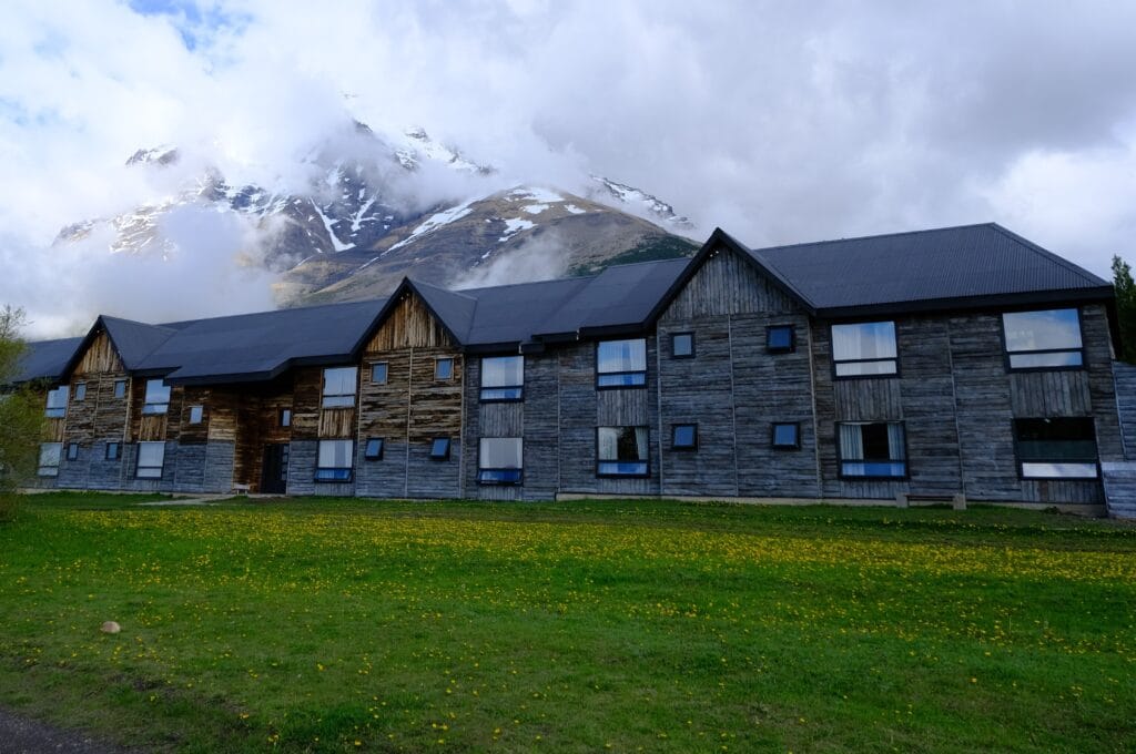 Las Torres Hotel in the Torres del Paine National Park showing wooden style builidng in front of the mountains