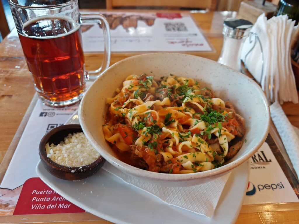 Miste Grande restaurant in Puerto Natales showing a lam pasta with Calatafe Beer