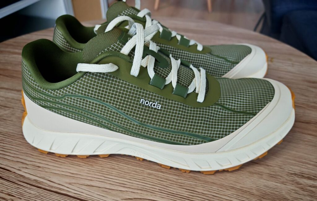 Side profile of the Men's Norda 002 Trail Running Shoe in Sage showing the Gum Vibram sole and Vibram SLE midsole along with Dyneema laces and upper material