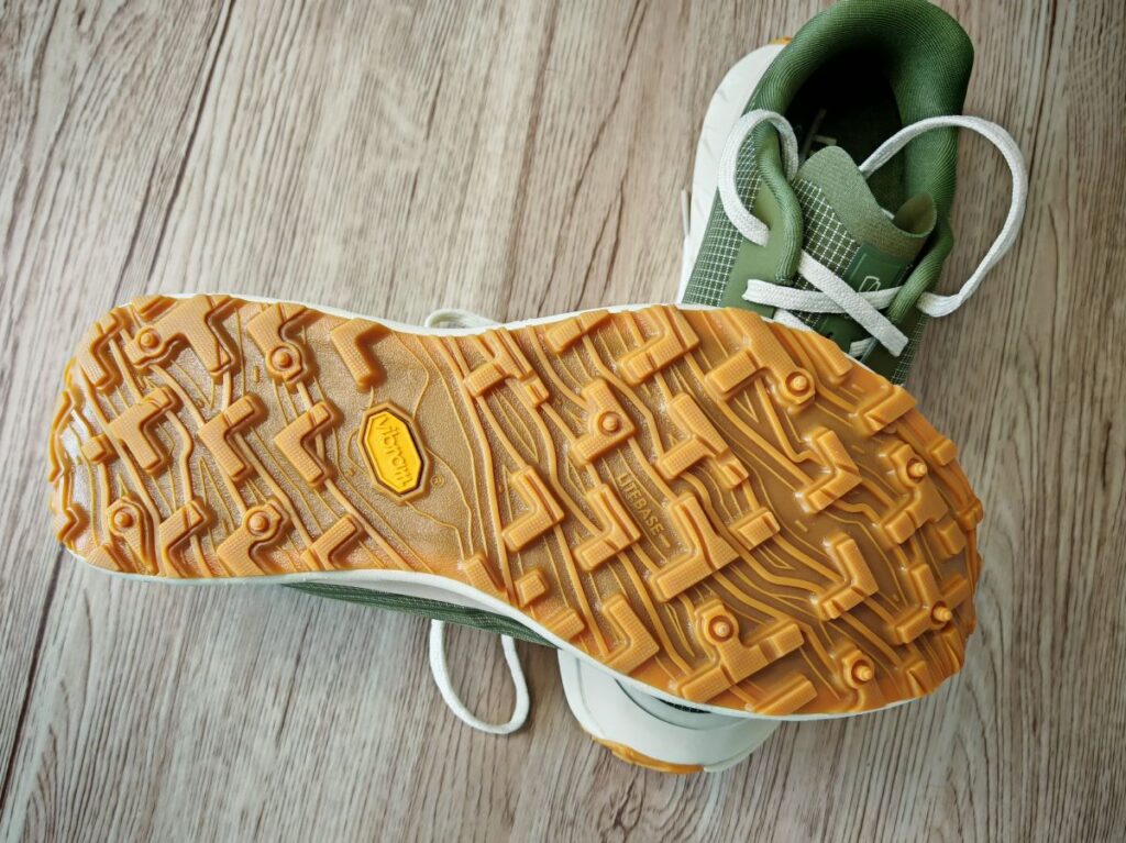 The bottom sole view of the Vibram MegaGrip with Litebase technology showing the mountain pattern of 5mm lugs on the Norda 002 shoes