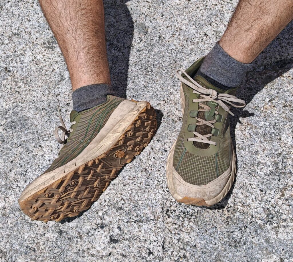 The sage green Norda 002 Mens shoe on Yosemite Granite whowing the Vibram sole and Dyneema Upper materials