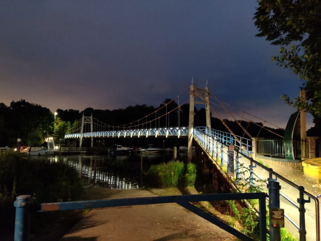 A nighttime photo of Teddington Bridge next to the Locks