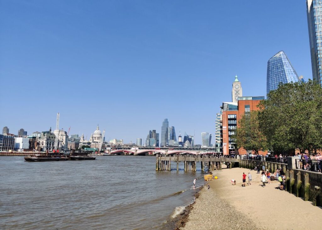 A rare beach in London on South Bank with the city skyline in the background