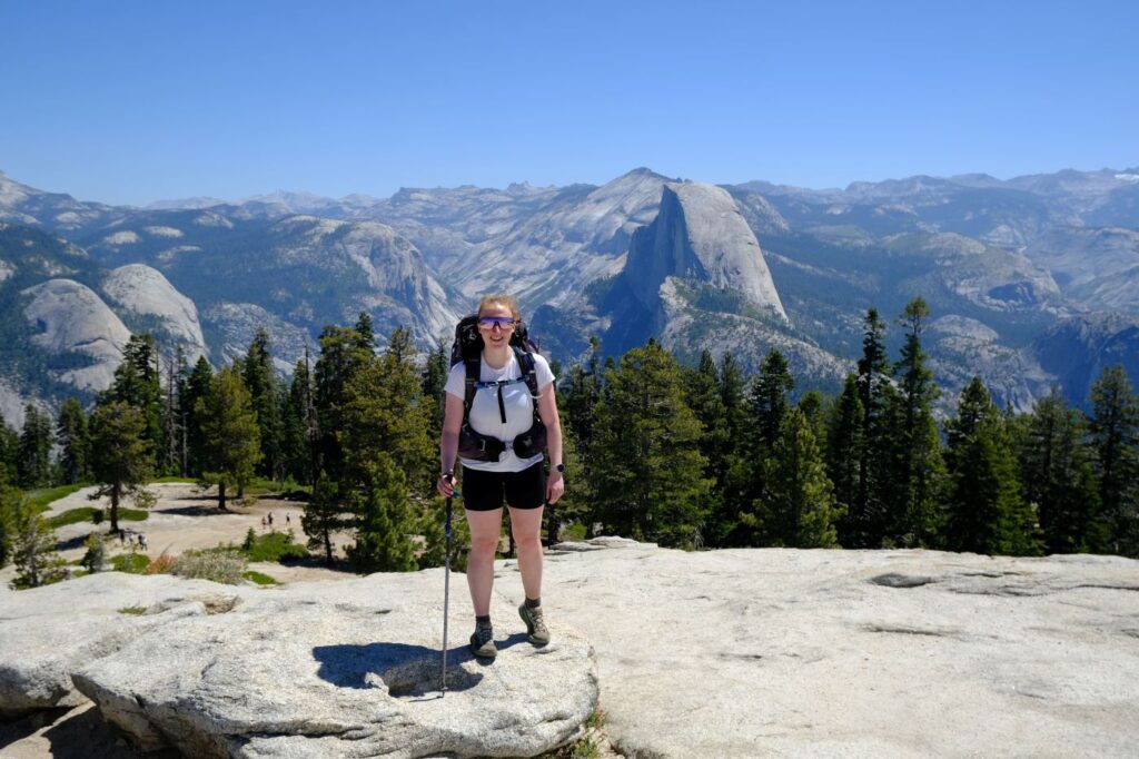 Female Backpacker at Sentinel Dome in Yosemite carrying an Osprey Aura AG 50 and Salomon Genesis shoes