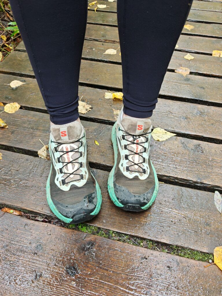 Top view of the Women's Salomon Genesis Trail Runners on wet board walk