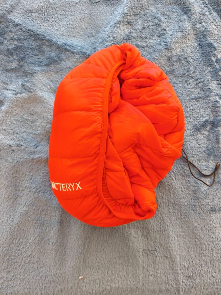 The Arc'teryx Cerium Hoody packed up into the hood. The chest pocket also serves as a stuff sack