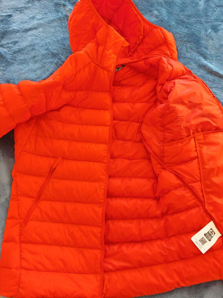 Orange Men's Arc'teryx Cerium Hoody unzipped showing 850 down fill baffles