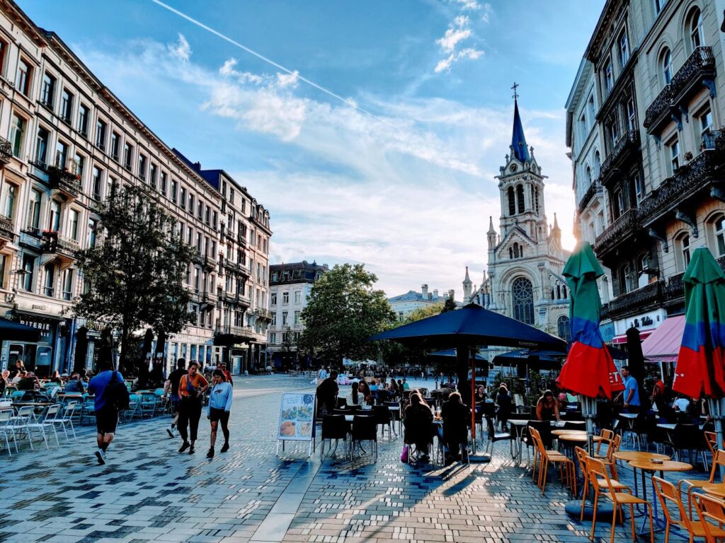 Saint Giles cafes and restaurants line the street with a church in the background