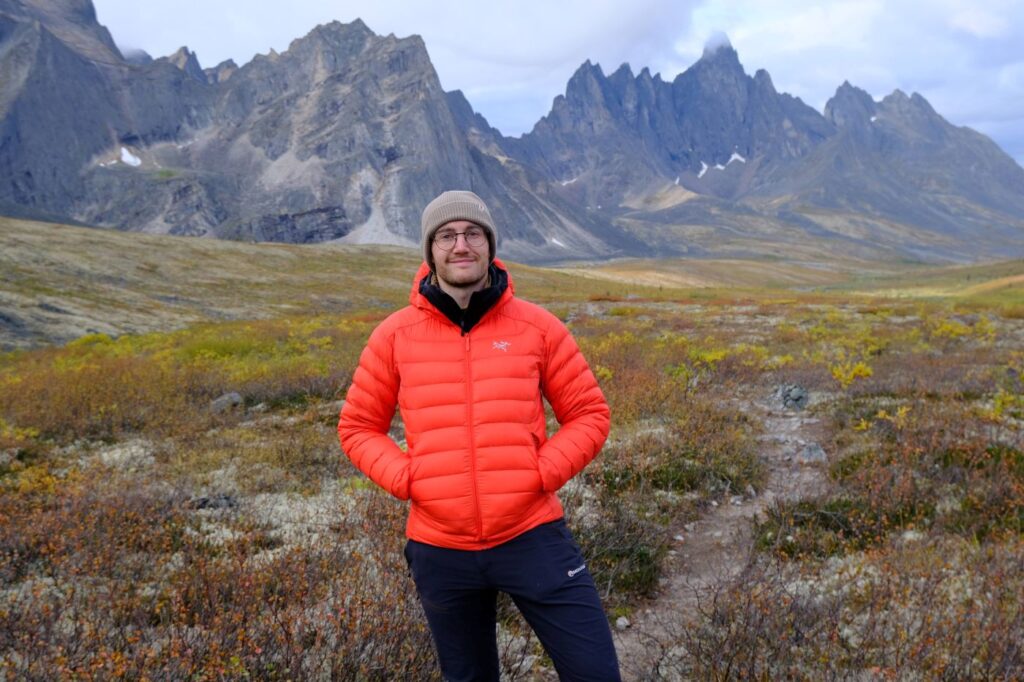 At Talus Lake in Yukon, a man wearing the Arc'teryx Cerium Down Jacket