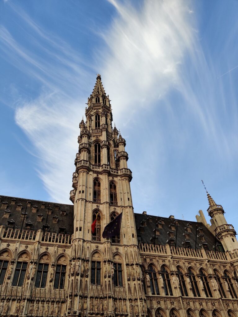 Grand Place Tower with blue sky background and sunrise light